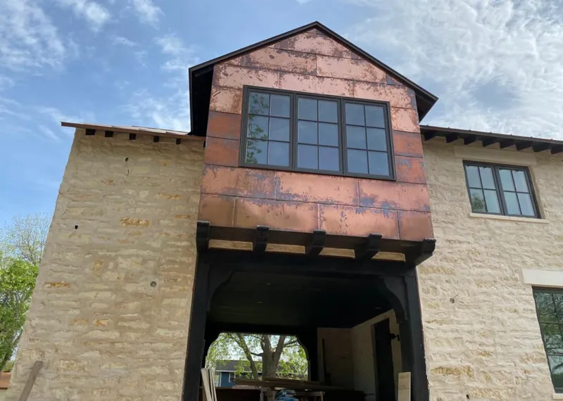 Copper metal panel facade on a stone building for Skylight Installation in Durango